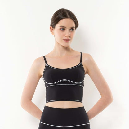 Model wearing a stylish 3D bra top in black with white detailing, perfect for activewear and casual outfits.